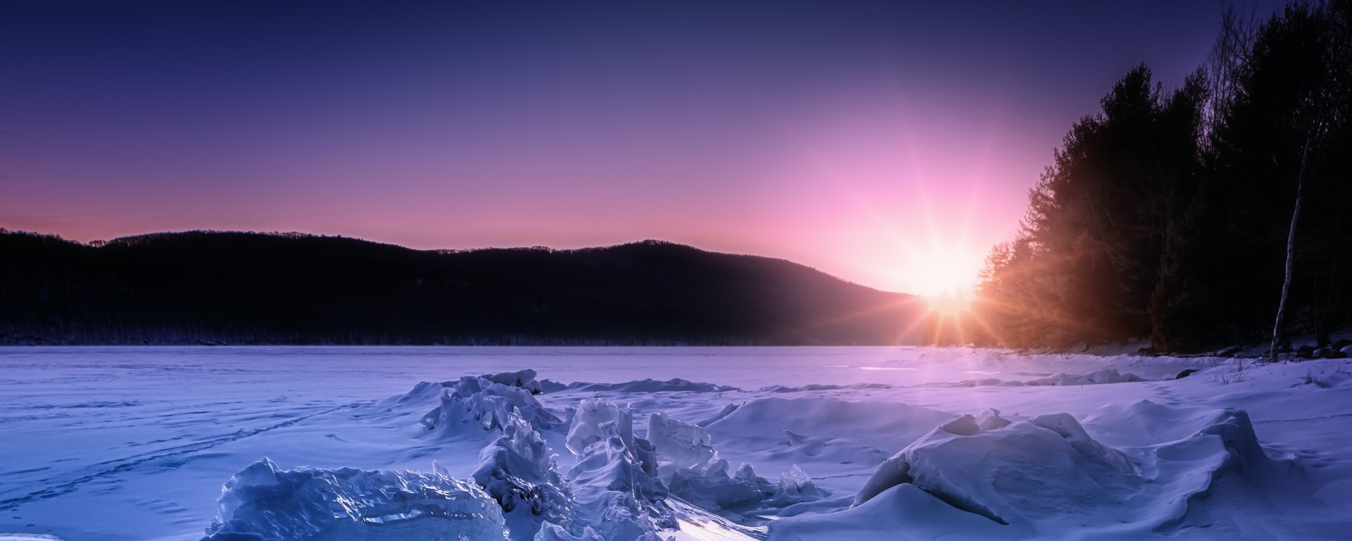 Sunrise over an icy lake