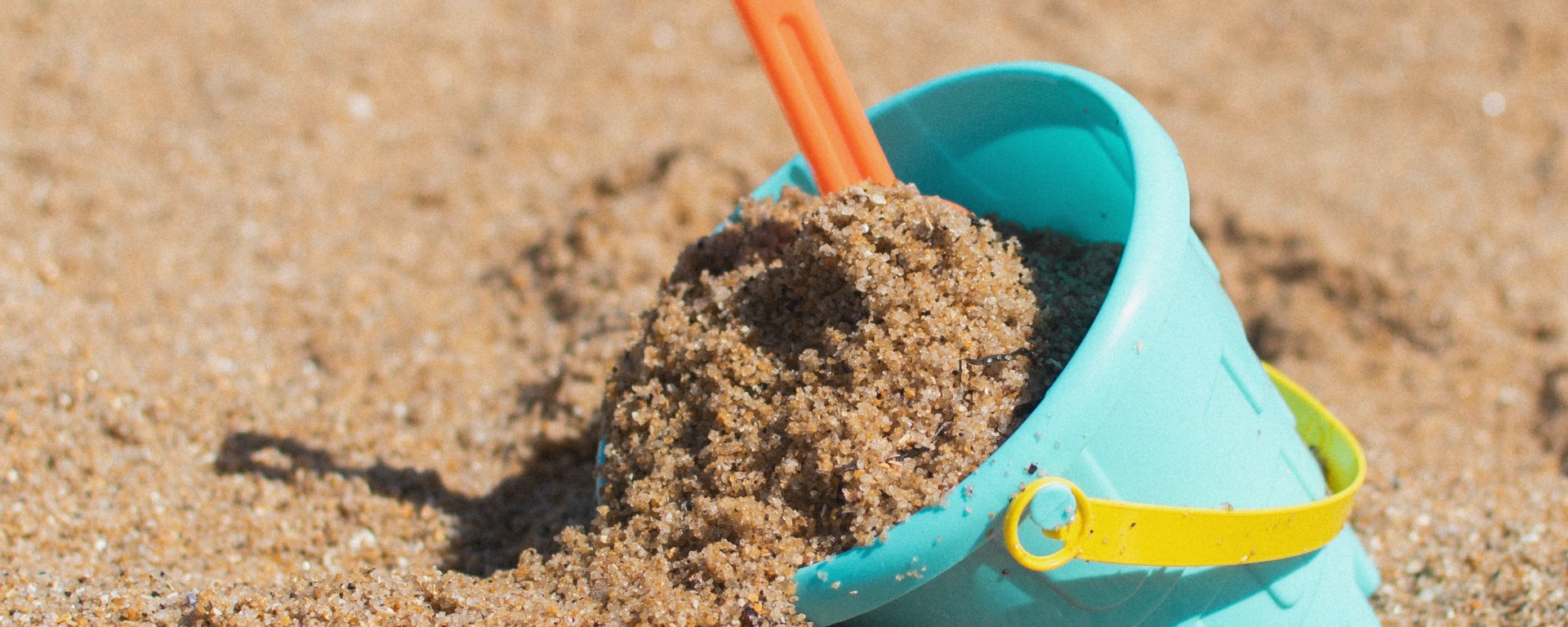 toy bucket in sand