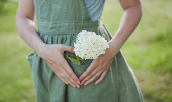 decorative. Women in a 1940's apron with a flower in her pocket.