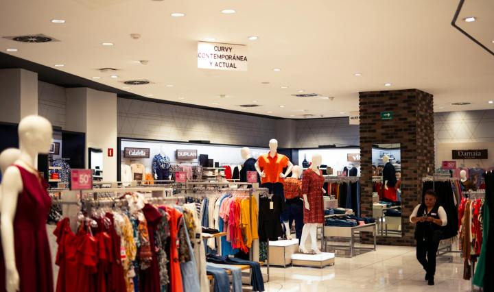 a store with many clothes on display and mannequins